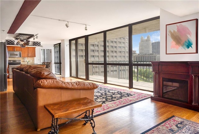 600 Admiral Blvd Unit 1505, Kansas City, MO 64106 - living room featuring wood finished floors, track lighting, a wall of windows, and a city view