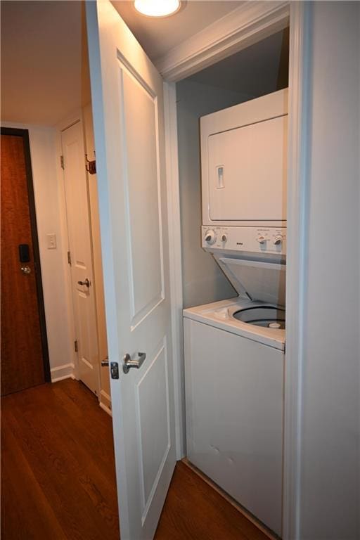 600 Admiral Blvd Unit 1505, Kansas City, MO 64106 - washroom featuring estacked washer and dryer and dark wood finished floors
