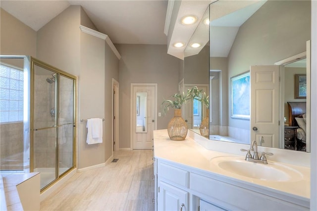 16042 Overbrook Ln, Stilwell, KS 66085 - bathroom featuring a stall shower, vanity, wood finished floors, plenty of natural light, and recessed lighting