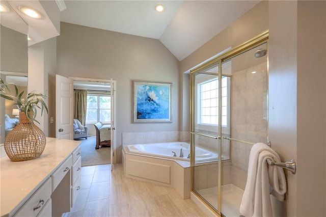16042 Overbrook Ln, Stilwell, KS 66085 - bathroom featuring vanity, a bath, a stall shower, vaulted ceiling, and ensuite bath