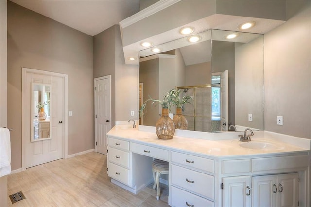 16042 Overbrook Ln, Stilwell, KS 66085 - bathroom featuring double vanity, a shower with door, and wood finished floors