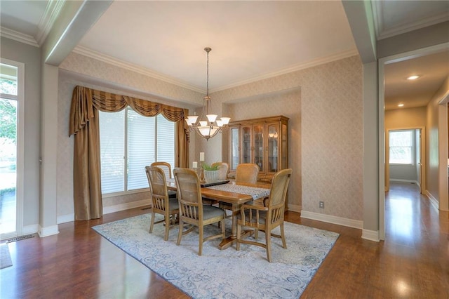 16042 Overbrook Ln, Stilwell, KS 66085 - dining area with dark wood finished floors, a chandelier, and ornamental molding