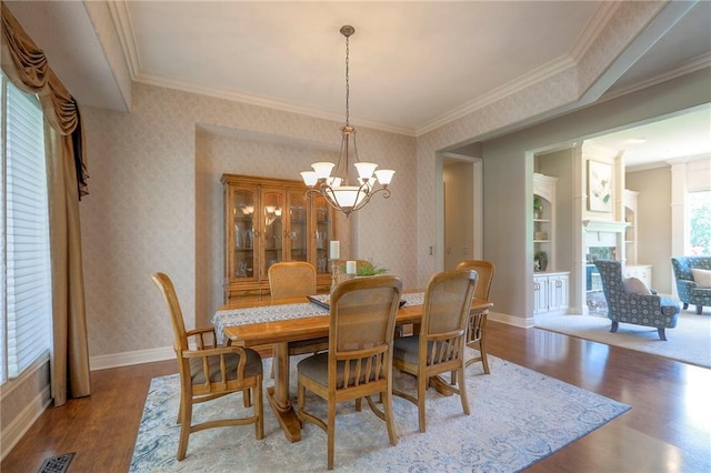 16042 Overbrook Ln, Stilwell, KS 66085 - dining area with wood finished floors, wallpapered walls, a chandelier, a fireplace, and crown molding