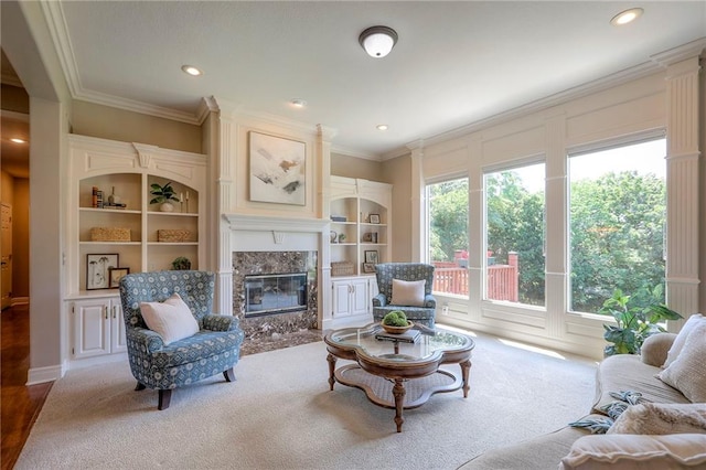 16042 Overbrook Ln, Stilwell, KS 66085 - living room featuring carpet, a premium fireplace, crown molding, built in shelves, and recessed lighting