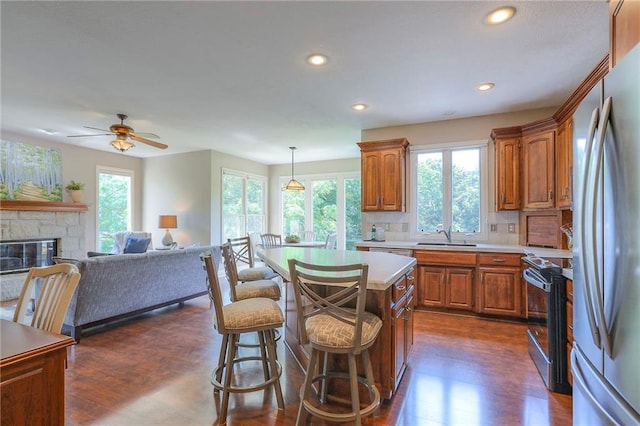 16042 Overbrook Ln, Stilwell, KS 66085 - kitchen with stainless steel appliances, healthy amount of natural light, light countertops, brown cabinets, and recessed lighting