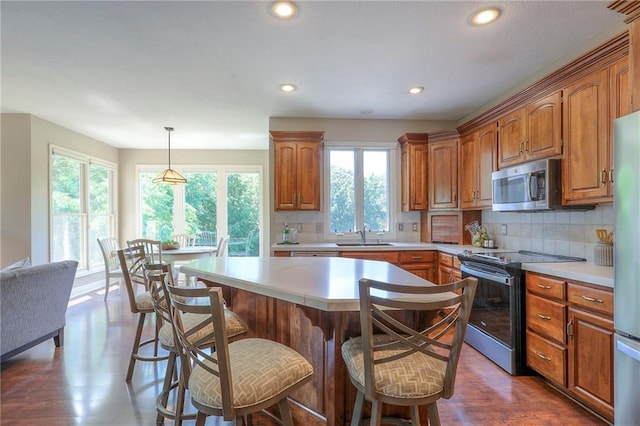 16042 Overbrook Ln, Stilwell, KS 66085 - kitchen with stainless steel microwave, range with electric cooktop, light countertops, decorative backsplash, and recessed lighting