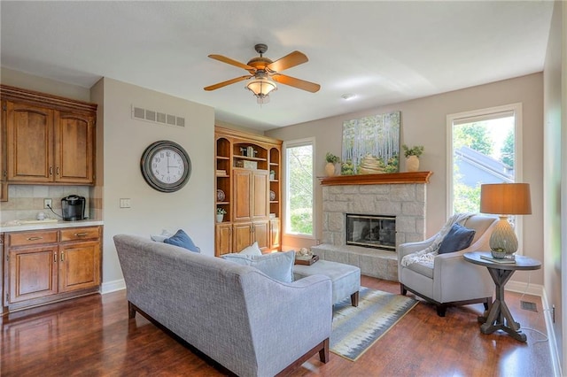 16042 Overbrook Ln, Stilwell, KS 66085 - living room featuring healthy amount of natural light, dark wood-style floors, and a fireplace
