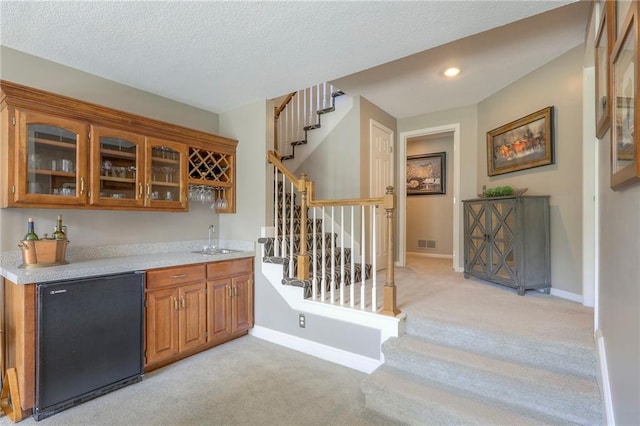 16042 Overbrook Ln, Stilwell, KS 66085 - indoor wet bar featuring light carpet, stairway, refrigerator, a textured ceiling, and recessed lighting