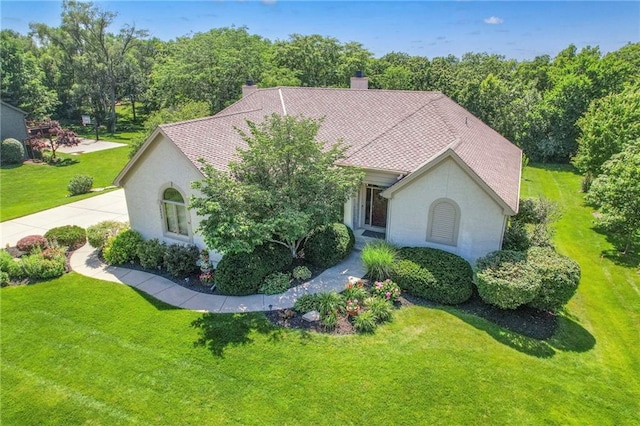 16042 Overbrook Ln, Stilwell, KS 66085 - view of front of house with a front lawn, stucco siding, and a chimney