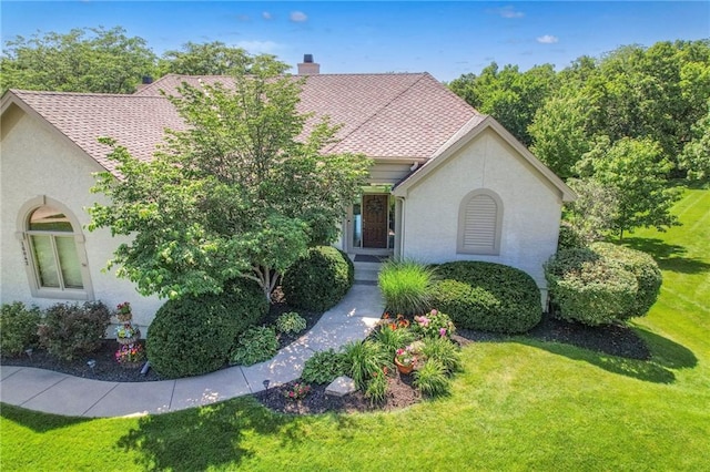 16042 Overbrook Ln, Stilwell, KS 66085 - view of front of home featuring a front lawn, a chimney, and stucco siding