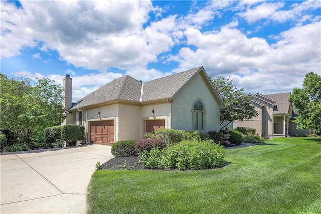 16042 Overbrook Ln, Stilwell, KS 66085 - view of side of home with a chimney, stucco siding, a garage, a lawn, and concrete driveway