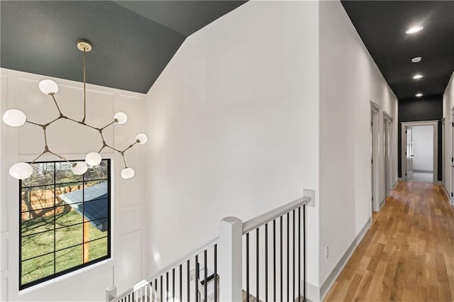 6000 El Monte St, Fairway, KS 66205 - hallway featuring a chandelier, light wood finished floors, lofted ceiling, and an upstairs landing