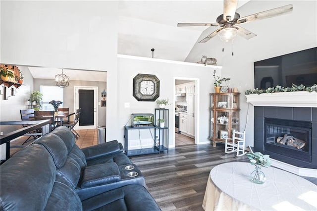 4416 Broadway Ter, Leavenworth, KS 66048 - living room with high vaulted ceiling, ceiling fan, wood finished floors, a tiled fireplace, and a chandelier