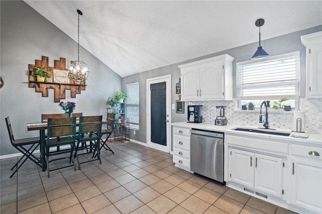 4416 Broadway Ter, Leavenworth, KS 66048 - kitchen featuring stainless steel dishwasher, vaulted ceiling, a chandelier, decorative backsplash, and light countertops