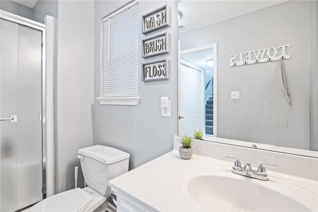 4416 Broadway Ter, Leavenworth, KS 66048 - full bathroom featuring a shower stall, vanity, and a textured ceiling