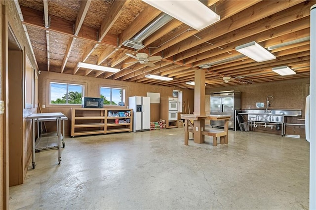 204 E Casey Rd, Lone Jack, MO 64070 - below grade area featuring white fridge with ice dispenser and stainless steel fridge