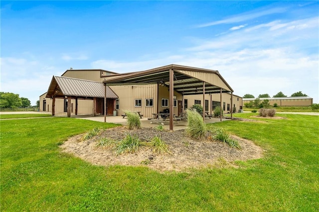 204 E Casey Rd, Lone Jack, MO 64070 - rear view of house featuring a patio and a lawn