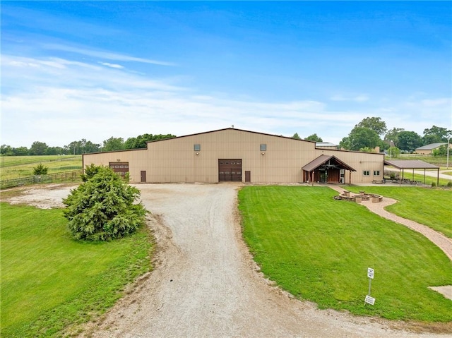 204 E Casey Rd, Lone Jack, MO 64070 - view of front facade featuring a garage, a pole building, a front yard, an outbuilding, and driveway
