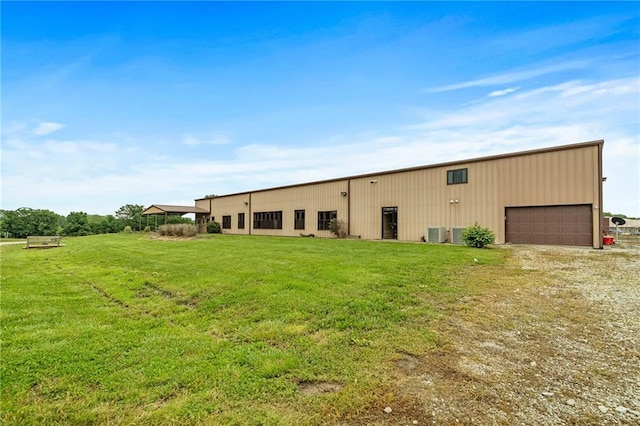 204 E Casey Rd, Lone Jack, MO 64070 - view of front facade featuring a front yard, driveway, a garage, and an outbuilding