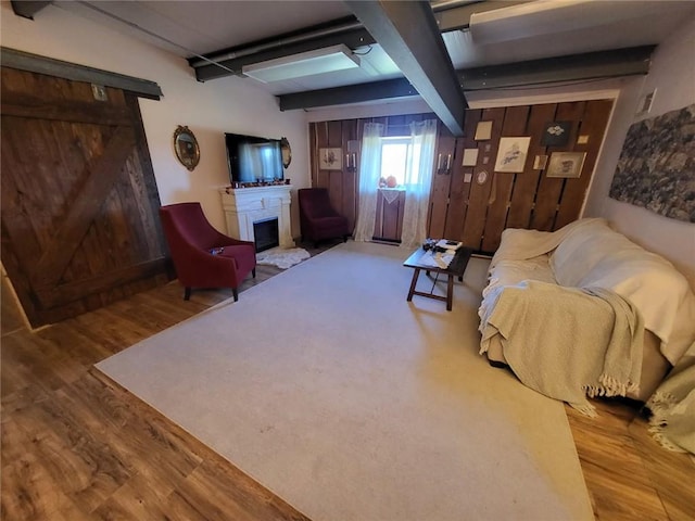 204 E Casey Rd, Lone Jack, MO 64070 - living room with wood finished floors, beam ceiling, and a fireplace