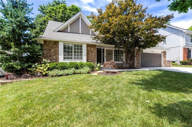 10136 Barton St, Overland Park, KS 66214 - view of front of home with stone siding, concrete driveway, and a front yard