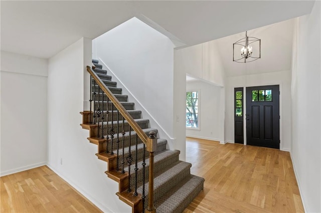 10136 Barton St, Overland Park, KS 66214 - entrance foyer featuring stairway, a chandelier, and light wood-type flooring