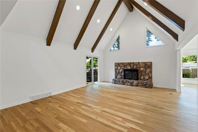 10136 Barton St, Overland Park, KS 66214 - unfurnished living room with high vaulted ceiling, light wood finished floors, beamed ceiling, recessed lighting, and healthy amount of natural light