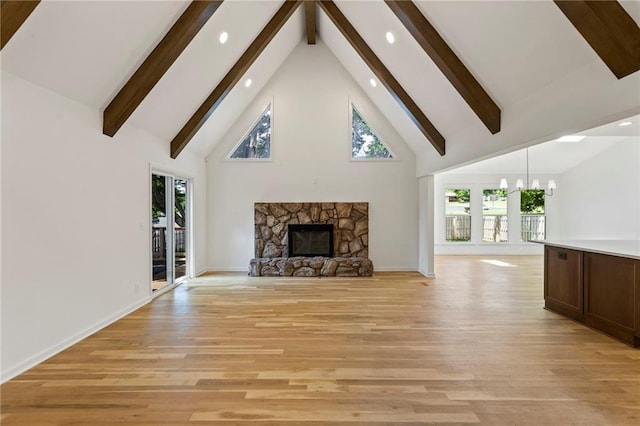 10136 Barton St, Overland Park, KS 66214 - unfurnished living room featuring light wood-style floors, beamed ceiling, recessed lighting, high vaulted ceiling, and a stone fireplace