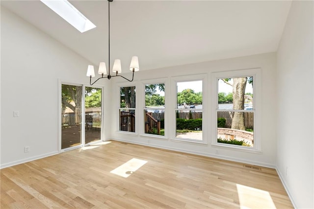 10136 Barton St, Overland Park, KS 66214 - unfurnished dining area with a skylight, vaulted ceiling, plenty of natural light, a chandelier, and light wood-style floors