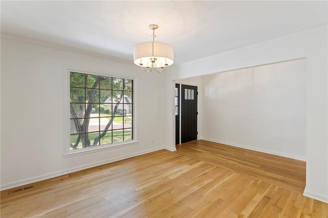 10136 Barton St, Overland Park, KS 66214 - unfurnished room with a chandelier, light wood-style flooring, and ornamental molding