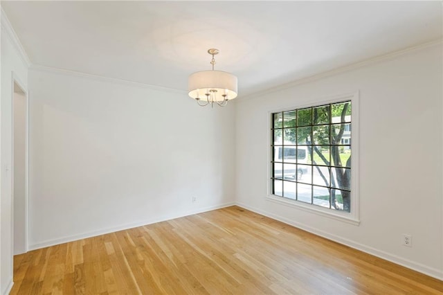 10136 Barton St, Overland Park, KS 66214 - spare room with ornamental molding, a chandelier, and light wood-style floors