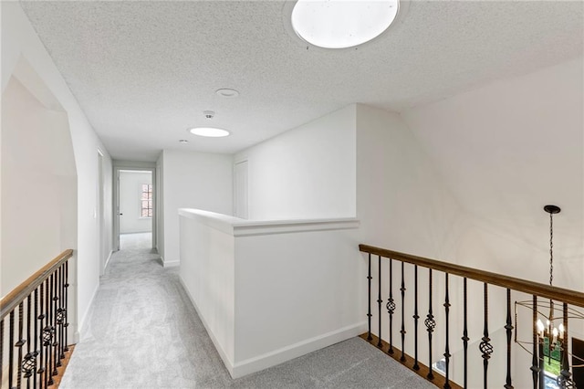 10136 Barton St, Overland Park, KS 66214 - hallway featuring an upstairs landing, carpet, and a textured ceiling