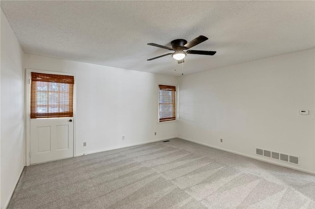 10136 Barton St, Overland Park, KS 66214 - spare room featuring light colored carpet, a textured ceiling, and a ceiling fan
