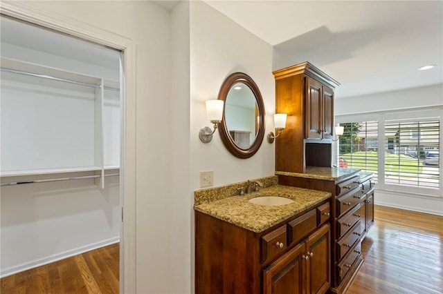10136 Barton St, Overland Park, KS 66214 - bathroom featuring wood finished floors and vanity