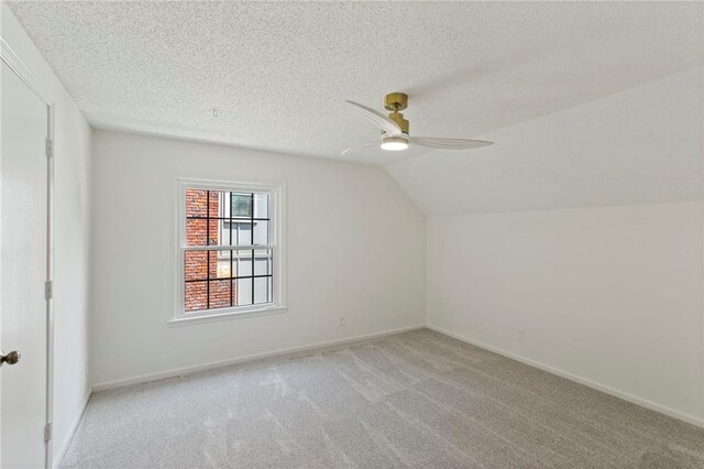 10136 Barton St, Overland Park, KS 66214 - bonus room featuring ceiling fan, light carpet, lofted ceiling, and a textured ceiling