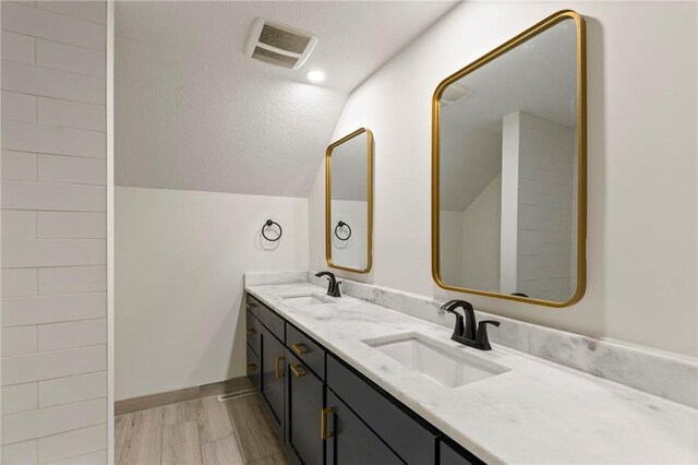 10136 Barton St, Overland Park, KS 66214 - full bath featuring double vanity, lofted ceiling, and wood finished floors
