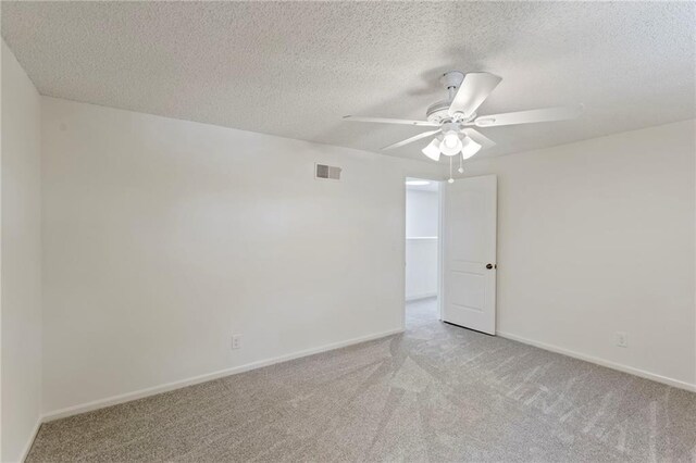 10136 Barton St, Overland Park, KS 66214 - unfurnished room with light carpet, ceiling fan, and a textured ceiling