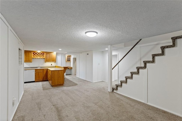 10136 Barton St, Overland Park, KS 66214 - kitchen with dishwasher, light carpet, brown cabinetry, a peninsula, and light countertops