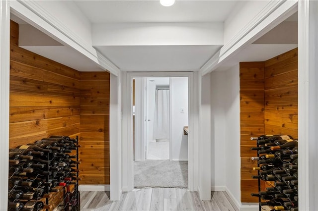 10136 Barton St, Overland Park, KS 66214 - wine room featuring light wood-style floors and wooden walls