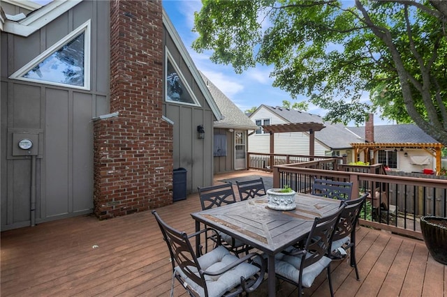 10136 Barton St, Overland Park, KS 66214 - wooden deck with outdoor dining area and a pergola