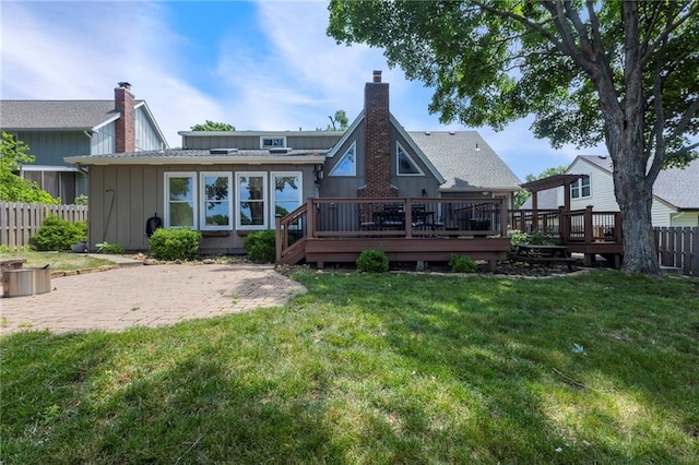 10136 Barton St, Overland Park, KS 66214 - rear view of house featuring board and batten siding, a chimney, a wooden deck, and a patio area