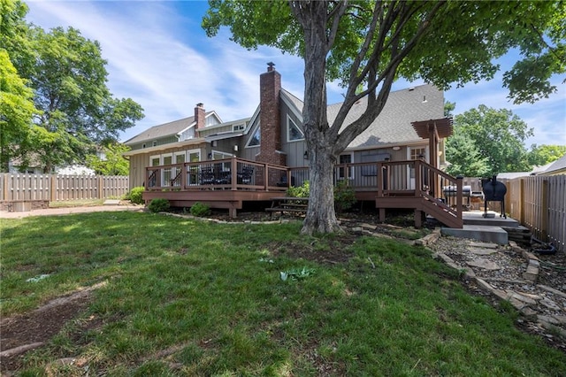 10136 Barton St, Overland Park, KS 66214 - back of house with board and batten siding, a fenced backyard, a deck, and a chimney