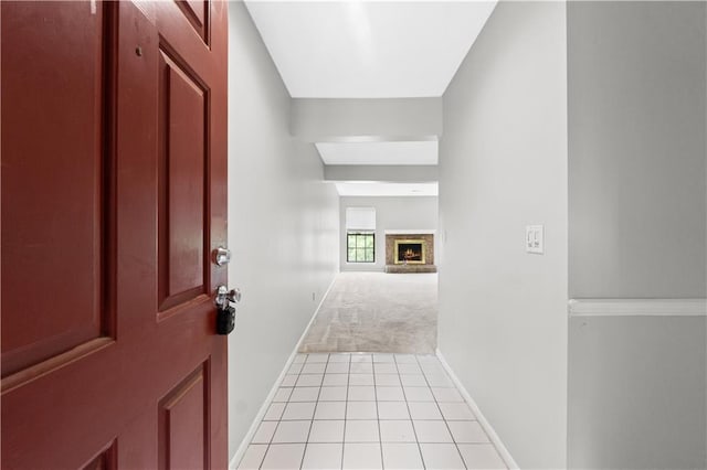 12740 W 110th Ter, Overland Park, KS 66210 - foyer entrance with a lit fireplace, light tile patterned flooring, and light carpet