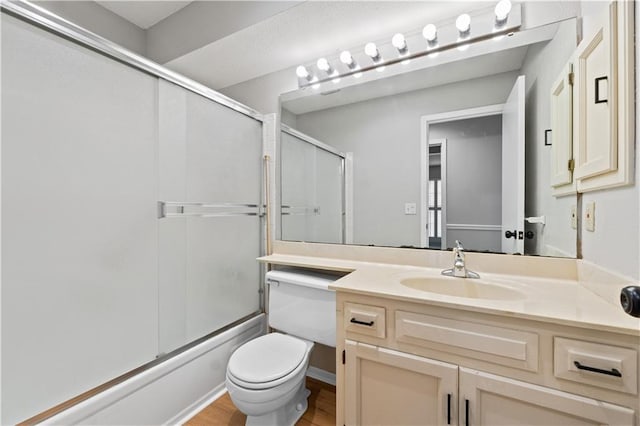 12740 W 110th Ter, Overland Park, KS 66210 - bathroom with vanity, bath / shower combo with glass door, and wood finished floors