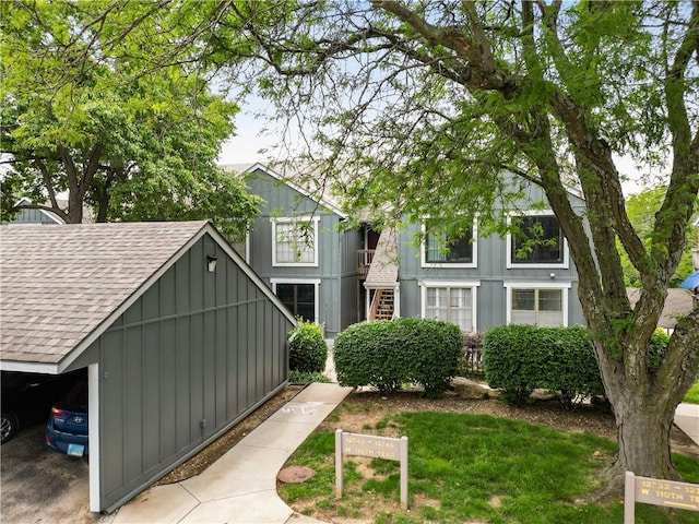 12740 W 110th Ter, Overland Park, KS 66210 - tudor house featuring a shingled roof and board and batten siding