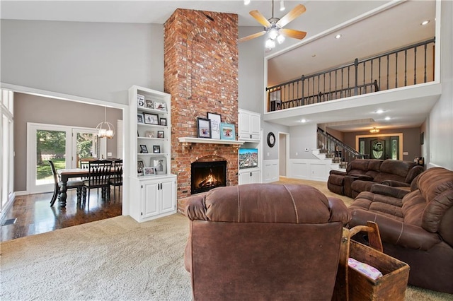 414 N 4th St, Gower, MO 64454 - living room featuring high vaulted ceiling, a ceiling fan, light colored carpet, stairs, and a brick fireplace