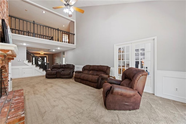 414 N 4th St, Gower, MO 64454 - living room with a decorative wall, carpet floors, stairs, a towering ceiling, and ceiling fan