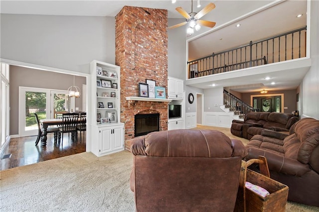 414 N 4th St, Gower, MO 64454 - living room featuring a towering ceiling, a ceiling fan, stairs, a fireplace, and light colored carpet