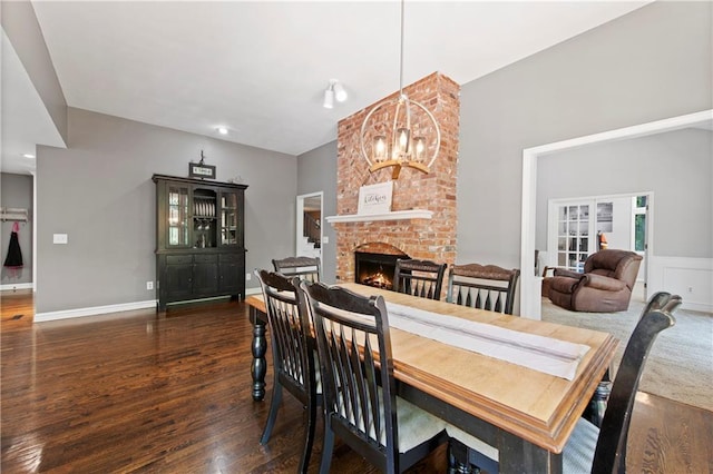 414 N 4th St, Gower, MO 64454 - dining area featuring a chandelier, wood finished floors, and a brick fireplace