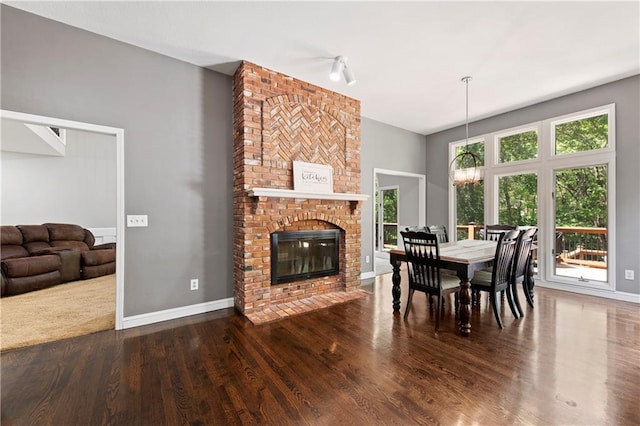 414 N 4th St, Gower, MO 64454 - dining area with wood finished floors, a fireplace, and a chandelier
